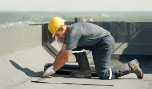 Roofing specialist working on commercial building